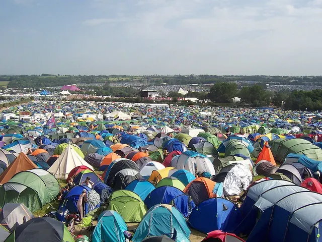 Tents pitched in a field at a camping festival