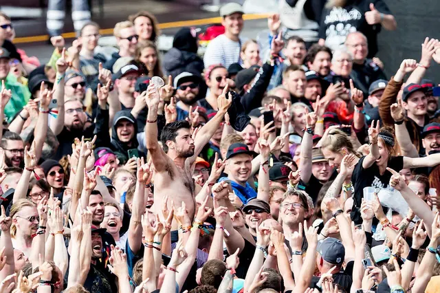 Lone concertgoer watching a band from the crowd