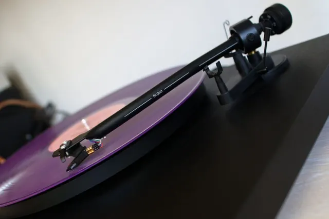 Stack of black vinyl records in plain sleeves