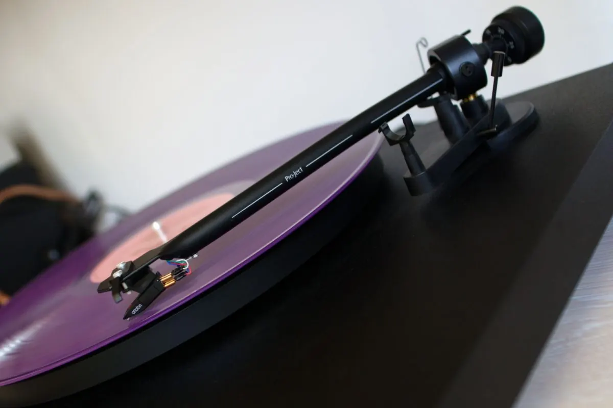 Stack of black vinyl records in plain sleeves
