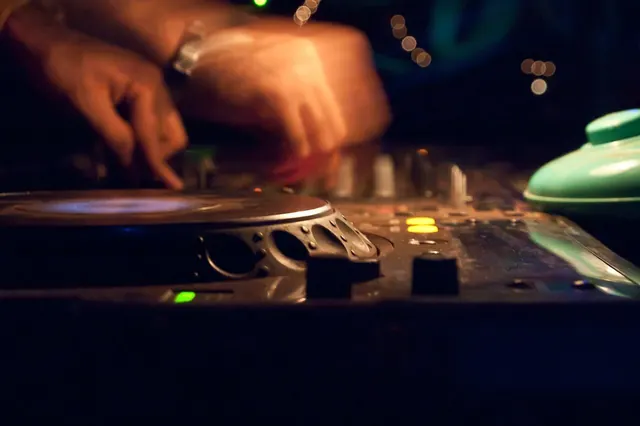 DJ mixing records in a dimly lit club